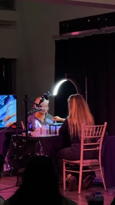 A live nail demonstration on the expo stage